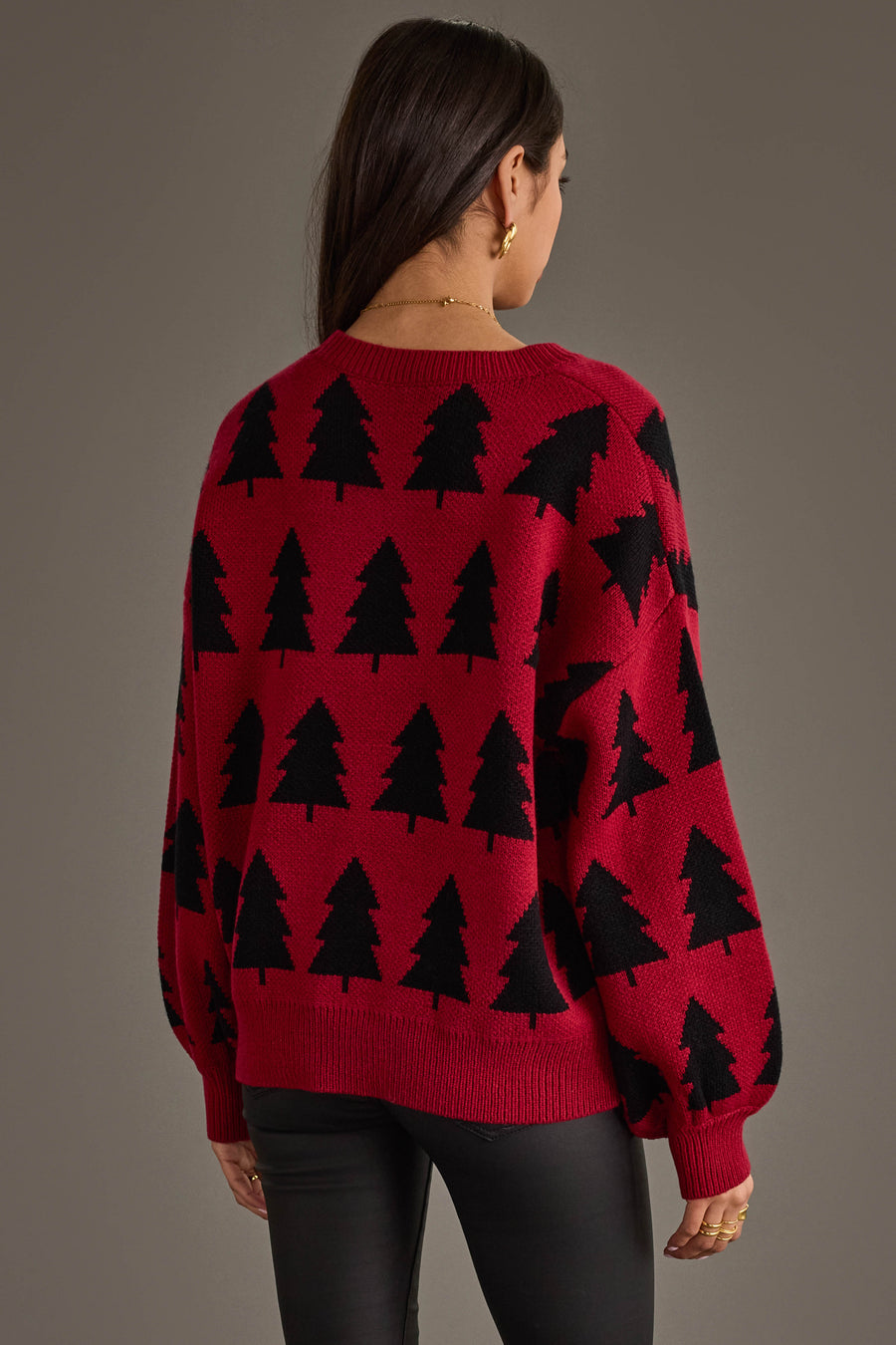 A person viewed from behind wearing a Panache Apparel Collection Red & Black Tree Sweater, a red crew-neck sweater patterned with black pine trees.