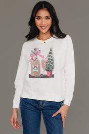 A woman wearing a white Panache Apparel Collection Christmas Champagne Sweatshirt featuring a graphic of a champagne bottle and a Christmas tree.