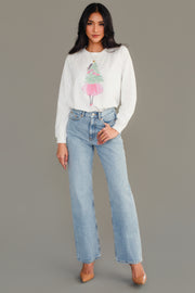A Panache Apparel Collection Pink Girl Holding Tree Sweatshirt in white, featuring a girl in a pink skirt standing in front of a green tree, worn with light-wash blue jeans and tan heels.