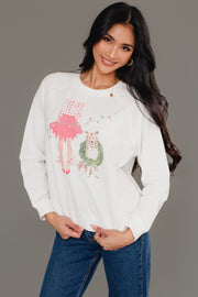 A woman wearing a white Christmas Girl & Dog Sweatshirt featuring a watercolor illustration of a girl holding a gift and a dog wearing a wreath.