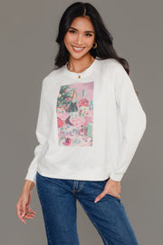 A woman wears a white long-sleeve Christmas Cocktails Scene Sweatshirt featuring a graphic of Christmas cocktails and decorations.
