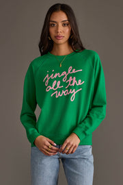 A bright green Panache Apparel Collection Green Jingle All The Way Sweatshirt featuring the words jingle all the way written in cursive pink script across the chest.