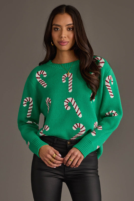 A bright green Candy Cane Sweater featuring a repeating white and red knit candy cane pattern.