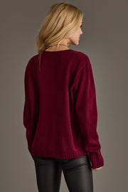 Back view of a person wearing a Merrier with a Martini Sweater, a long-sleeved, burgundy knit crewneck featuring a martini graphic.