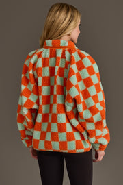 A person with long blonde hair is seen from behind, wearing the Panache Apparel Collection Orange & Light Blue Checkered Fleece Sweatshirt against a plain background.