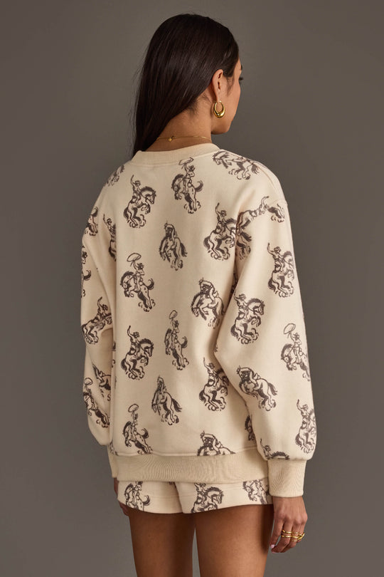 Back view of woman wearing Panache Apparel’s ivory western print sweatshirt and lounge shorts set.