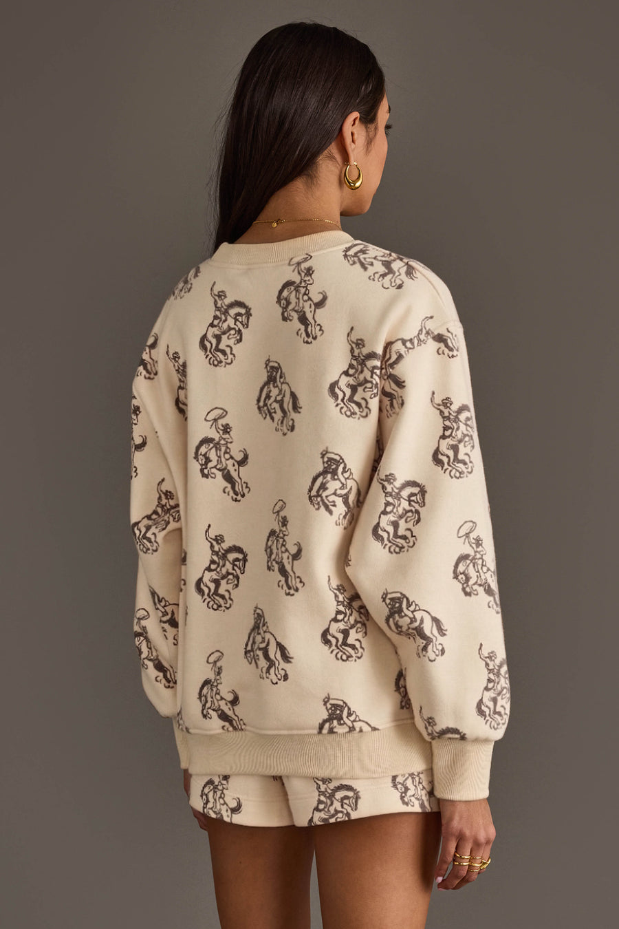 Back view of woman wearing Panache Apparel’s ivory western print sweatshirt and lounge shorts set.