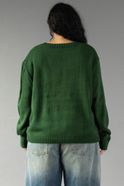 A person seen from behind, wearing a Hunter Green Merry Sweater and blue jeans.