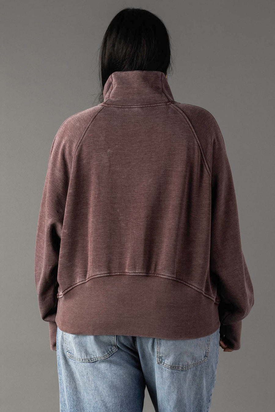 Back view of plus-size woman wearing Panache Apparel’s reddish-brown quarter zip sweatshirt.