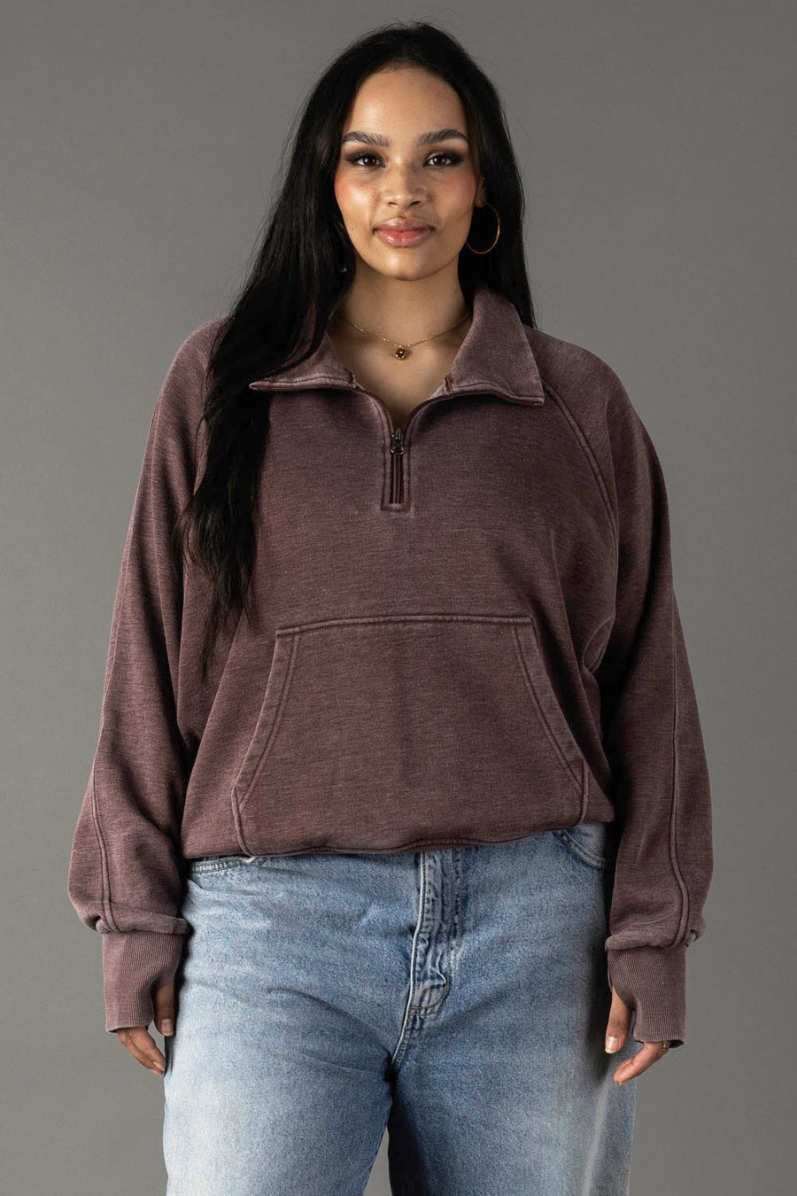 Plus-size woman wearing Panache Apparel’s reddish-brown quarter zip sweatshirt with an open collar.