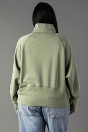 Back view of plus-size woman wearing Panache Apparel’s sage quarter zip sweatshirt.