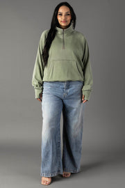 Full-length view of plus-size woman wearing Panache Apparel’s sage quarter zip sweatshirt.