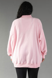 Back view of a person wearing a pink, long-sleeved, oversized Pink Merry & Cheers Reversible Sweatshirt with a mock neck.