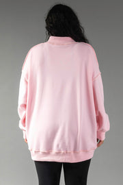 A person seen from behind wearing an oversized, long-sleeved light pink Pink Merry & Cheers Reversible Sweatshirt with a mock neckline.