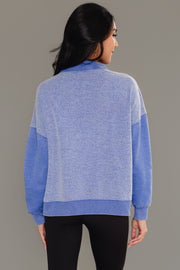 Back view of woman wearing Panache Apparel’s royal blue mixed media quarter zip sweatshirt.