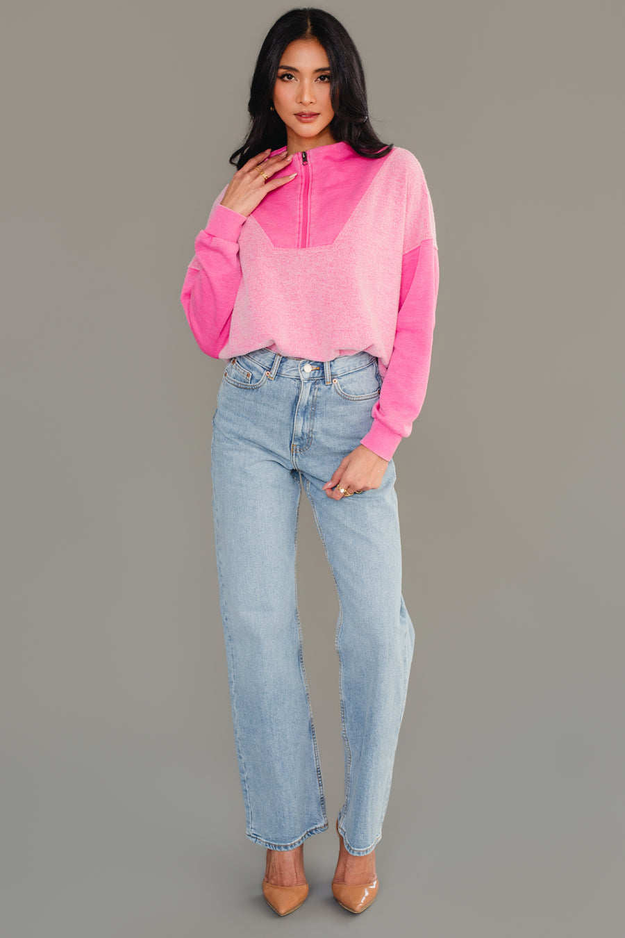 Full-length view of woman wearing Panache Apparel’s pink mixed media quarter zip sweatshirt.