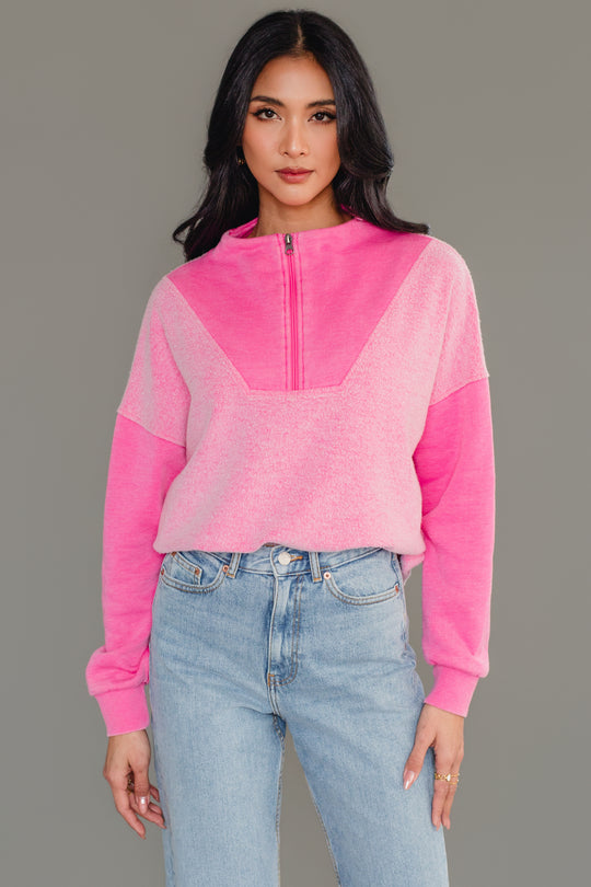 Woman wearing Panache Apparel’s pink mixed media quarter zip sweatshirt.