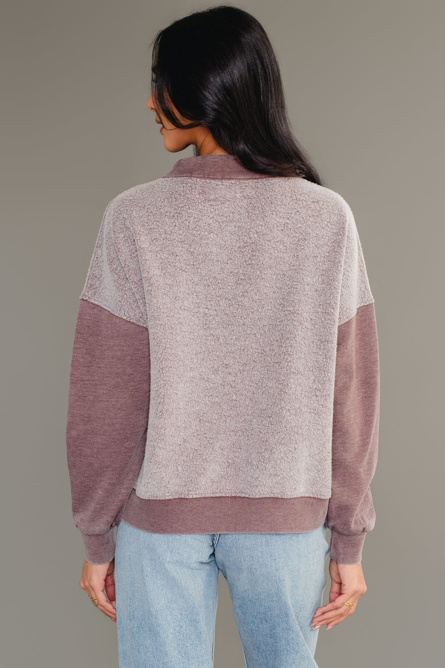 Back view of woman wearing Panache Apparel’s brown mixed media quarter zip sweatshirt.