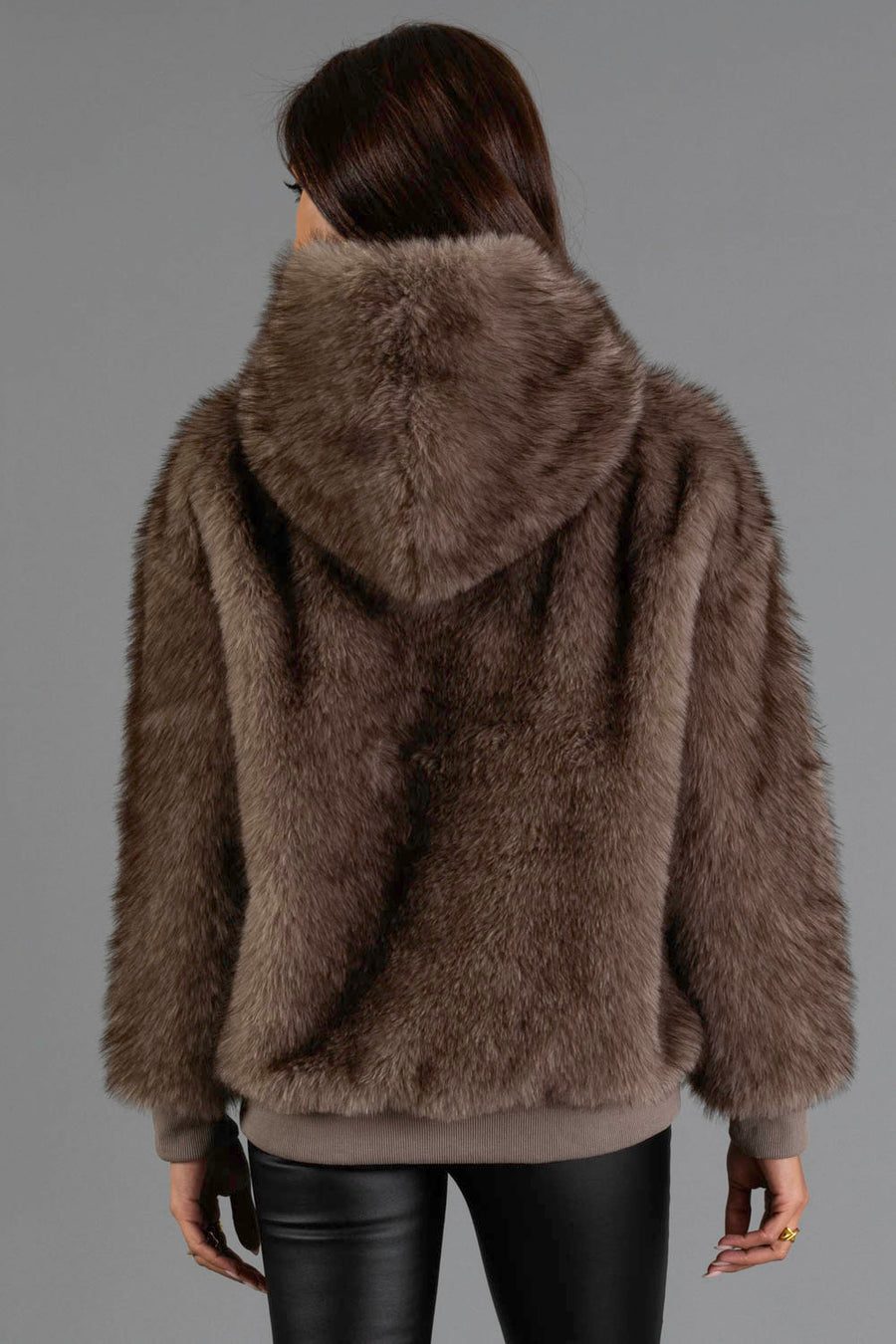 A person with long brown hair, seen from behind, is wearing the Panache Apparel Collection Gray/Brown Faux Fur Hooded Sweatshirt and black leather pants against a plain gray background.