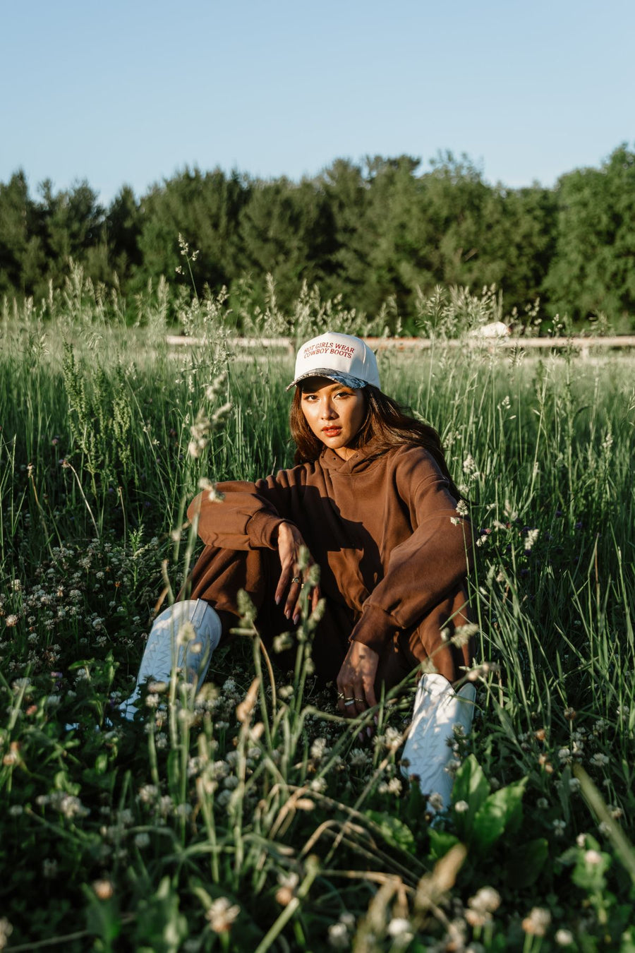 Outdoor seated view featuring Panache Apparel’s brown hoodie with coordinating sweatpants.