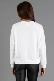 Back view of a person wearing a white Girl with Christmas Tree in Basket Sweatshirt by Panache Apparel Collection and black pants.
