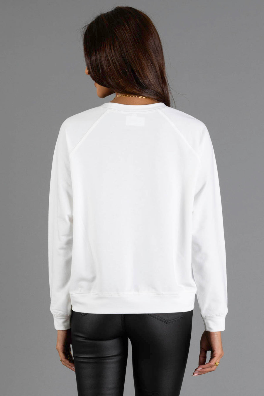 Back view of a person wearing a white Girl with Christmas Tree in Basket Sweatshirt by Panache Apparel Collection and black pants.