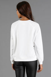 Back view of a person wearing a white Girl Carrying Presents & Tree Sweatshirt by Panache Apparel Collection.