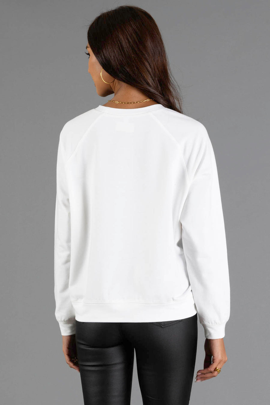 Back view of a person wearing a white Girl Carrying Presents & Tree Sweatshirt by Panache Apparel Collection.
