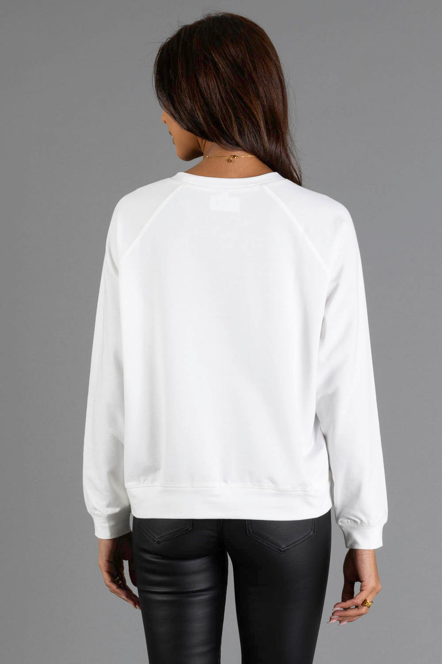 Back view of a person wearing a white long-sleeved Girl Walking Dog with Christmas Wreath Sweatshirt.