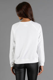 Back view of a person wearing a plain white long-sleeve Girl Carrying Christmas Presents Sweatshirt by Panache Apparel Collection and black pants.