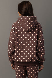 A person with long brown hair, seen from behind, is wearing the Panache Apparel Collection Brown & Light Pink Polka Dot Hooded Sweatshirt, standing against a plain gray background.