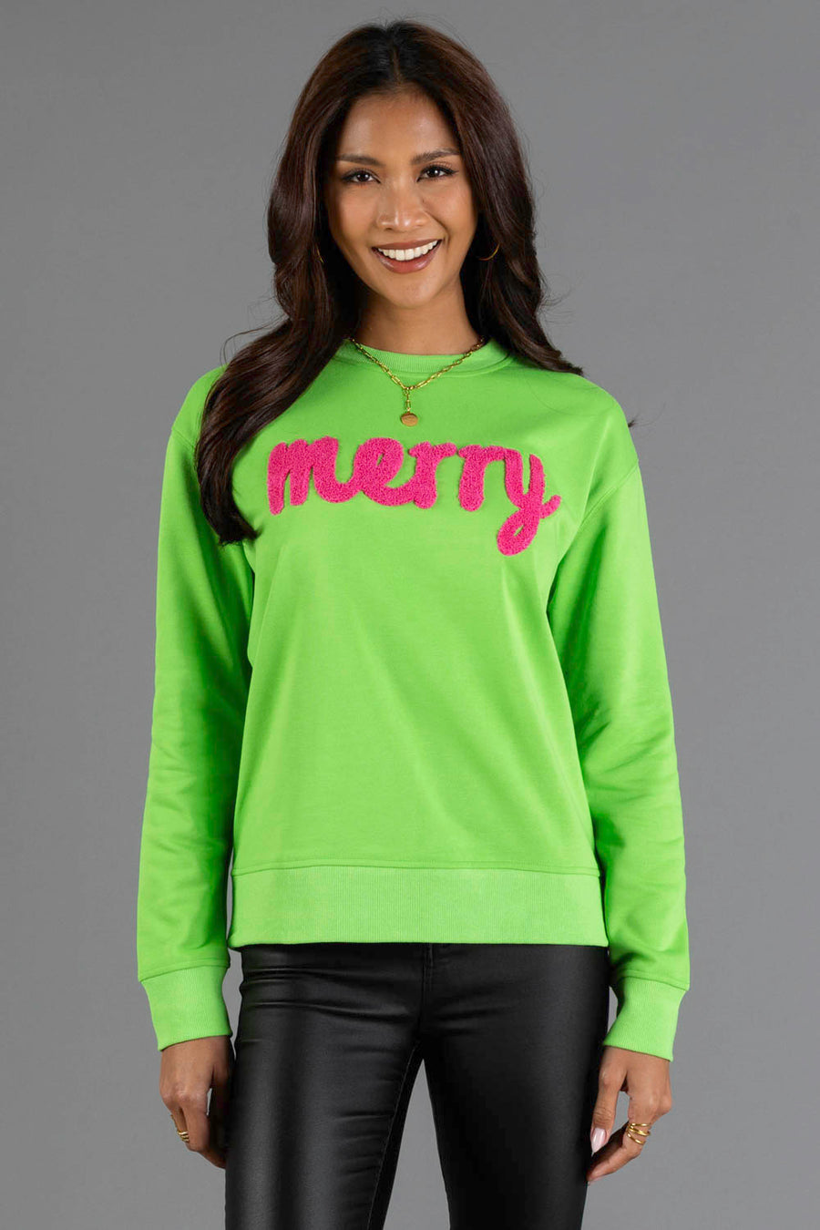 A Bright Green Merry Sweatshirt in bright green with textured pink letters across the chest.