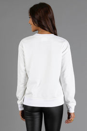 A person seen from the back wearing a white long-sleeved White Joyful Sweatshirt from the Panache Apparel Collection.