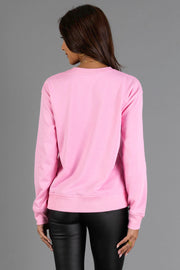 Back view of a person wearing a comfortable pink Pink Holly Jolly Sweatshirt.