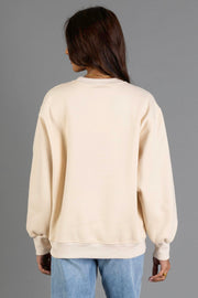 A person with long brown hair, wearing the Panache Apparel Collection’s Tan & Dark Brown Midwest Sweatshirt and blue jeans, stands facing away from the camera against a plain gray background.