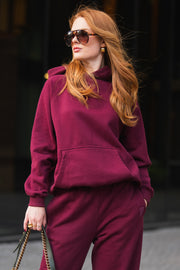 Person wearing a relaxed fit Maroon Panache Hooded Sweatshirt and matching sweatpants.