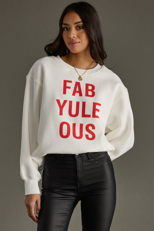 Woman wearing a white sweatshirt with red text on a gray background