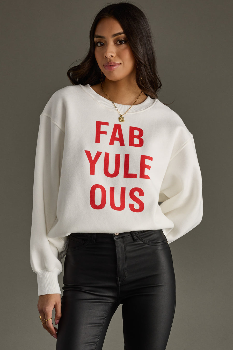 Woman wearing a white sweatshirt with red text on a gray background