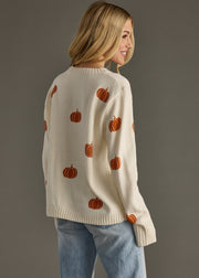 Back view of Panache Apparel’s ivory knit pumpkin sweater featuring an allover orange design.