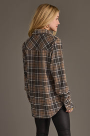 A woman with blonde hair, dressed in the Panache Apparel Collection’s Gray, Tan & White Plaid Button Up and black pants, stands facing away to display the back of the shirt.