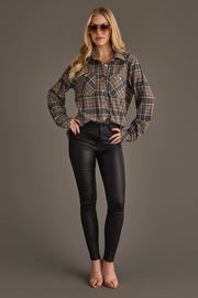 A woman with long blonde hair wearing sunglasses, black pants, and open-toe heels stands with her hands on her hips against a plain gray background, modeling the Gray, Tan & White Plaid Button Up from Panache Apparel Collection.