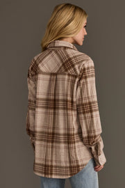 A woman with long blonde hair models the Panache Apparel Collection Brown, Tan & Rose Plaid Button Up, pairing it with light blue jeans and standing with her back to the camera against a plain background.