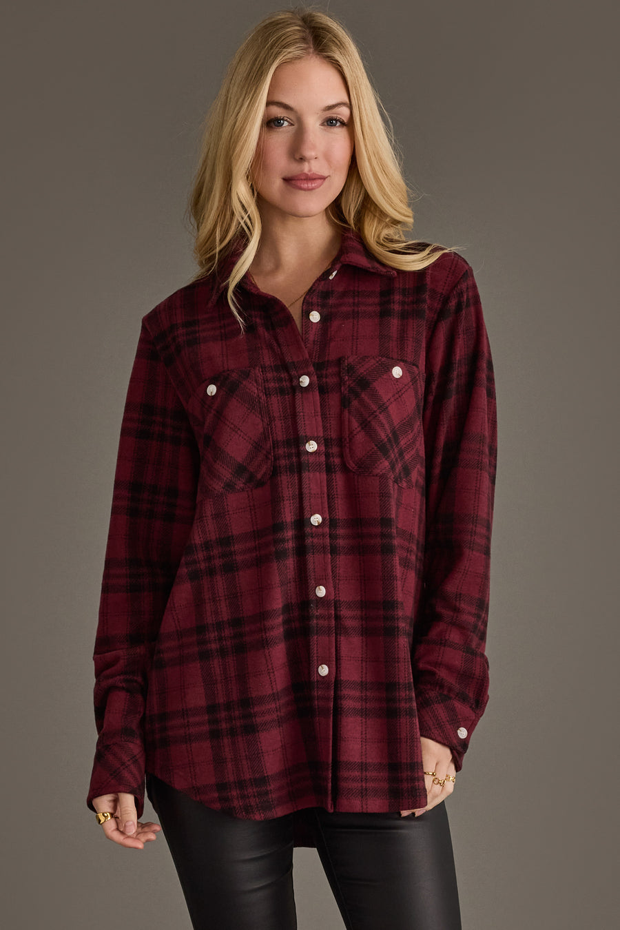 A woman with long blonde hair wears the Panache Apparel Collection Maroon & Black Plaid Button Up and black pants, standing against a plain gray background.