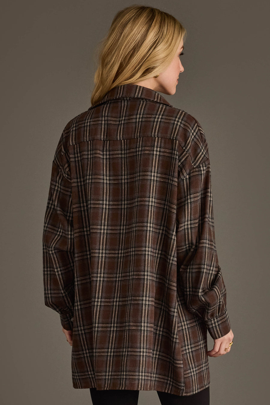 A person with long blonde hair, seen from the back, wears the Panache Apparel Collection Brown, Blue, Cream & Black Boyfriend Fit Plaid Button Up against a neutral background.