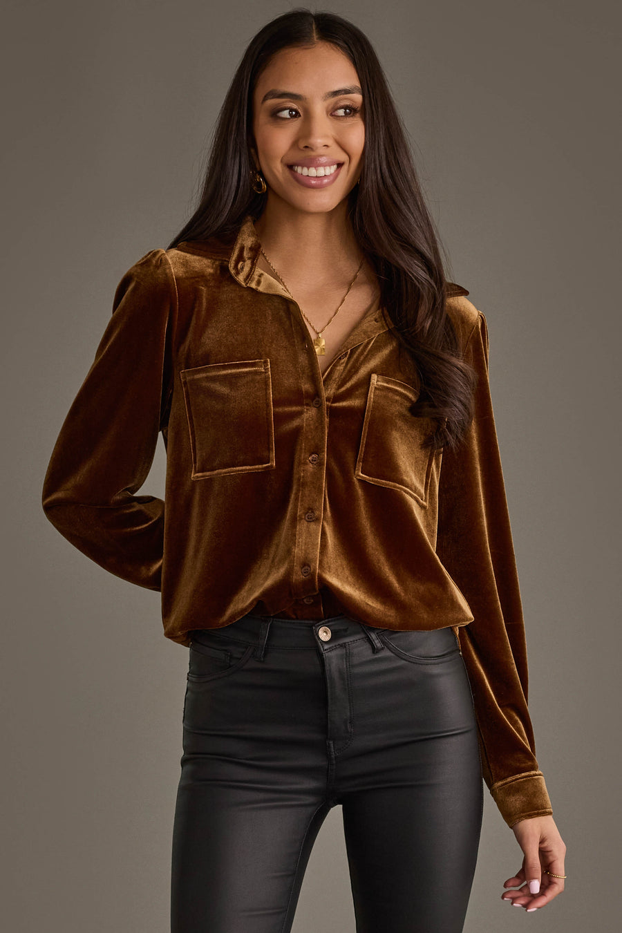 Woman with long dark hair wearing the Bronze Velvet Button Up by Panache Apparel Collection and black pants, smiling while standing against a plain gray background.
