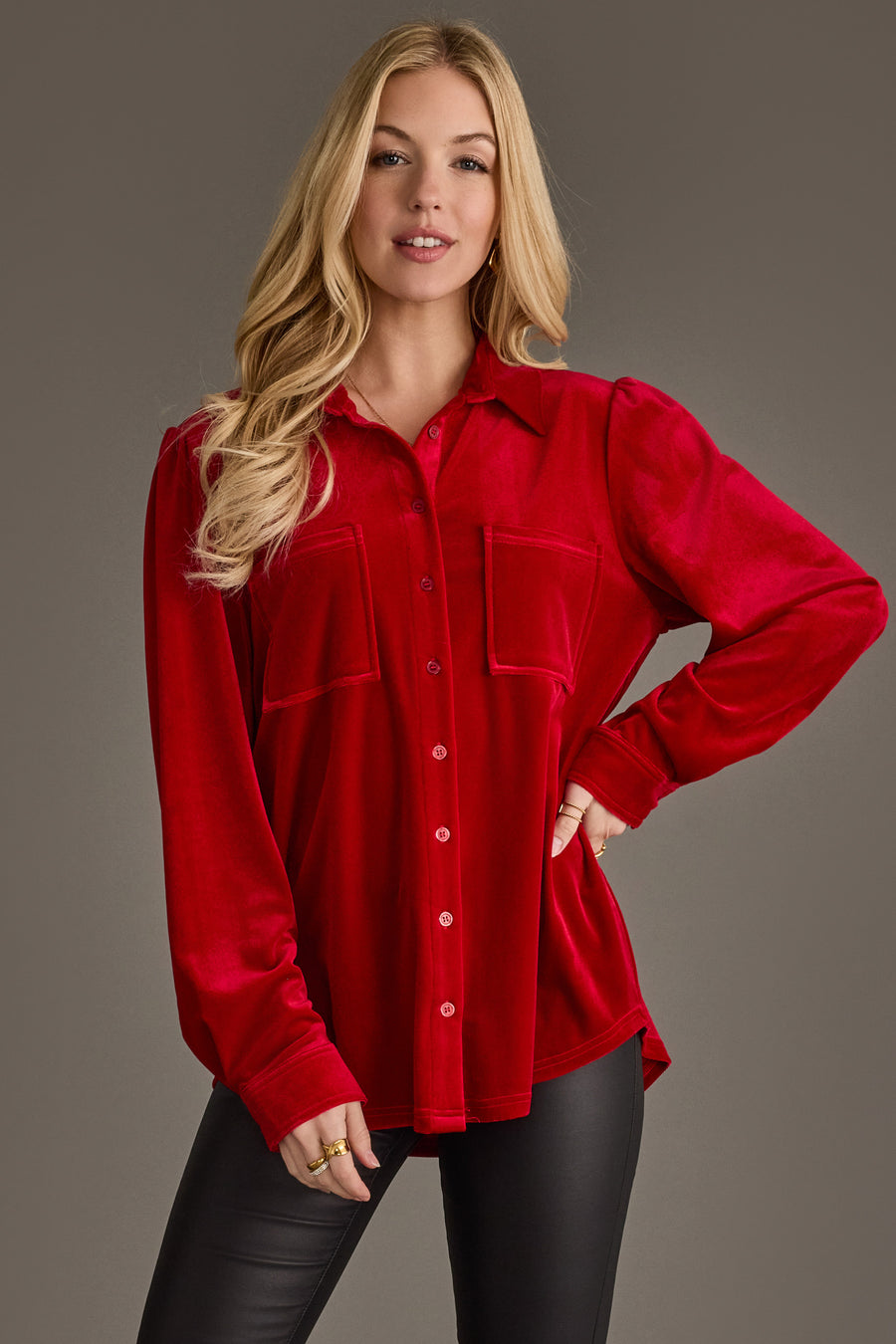A woman with long blonde hair models the Panache Apparel Collection Red Velvet Button Up with two front pockets, paired with black pants, standing confidently against a plain background.