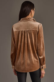 A woman with long brown hair is seen from behind wearing the Tan Velvet Button Up from Panache Apparel Collection and black pants, posed against a neutral background.
