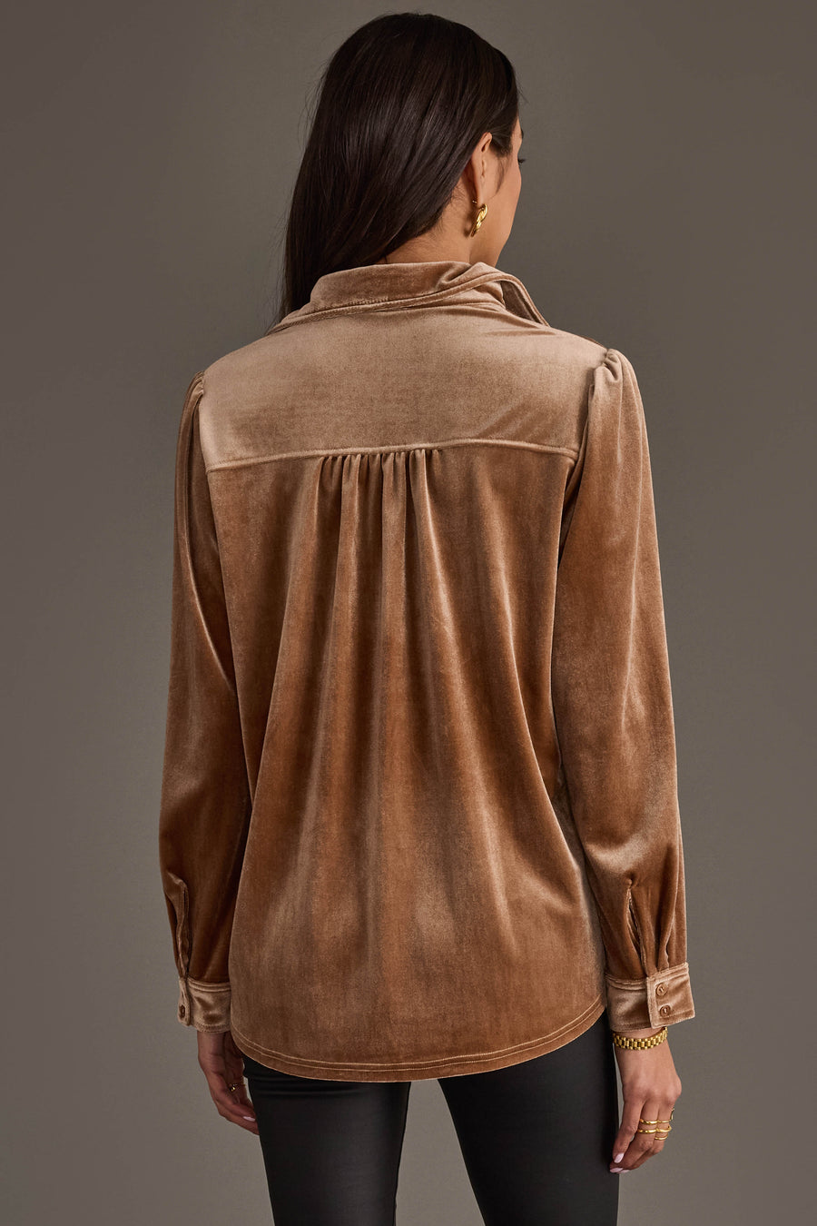 A woman with long brown hair is seen from behind wearing the Tan Velvet Button Up from Panache Apparel Collection and black pants, posed against a neutral background.