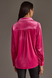 A person with long dark hair wears the Bright Pink Velvet Button Up by Panache Apparel Collection with black pants, shown from the back against a plain brown background.