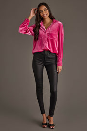 A woman stands and smiles wearing the Panache Apparel Collection Bright Pink Velvet Button Up, paired with black fitted pants and open-toe heels, posing against a plain gray background.